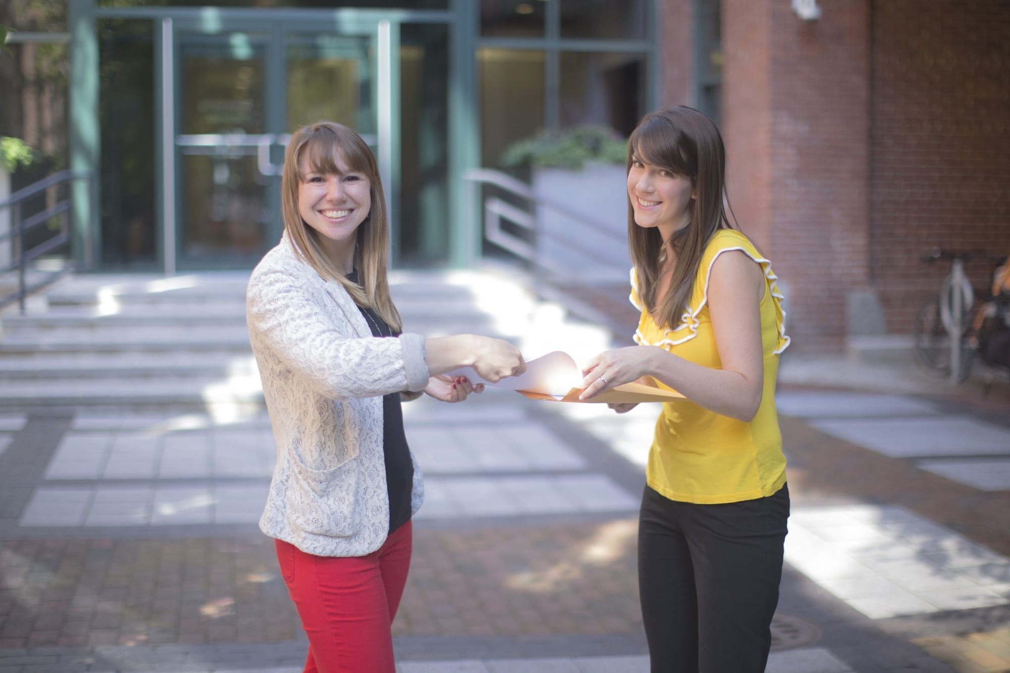 Image of two women making a transaction due to increased conversion rates