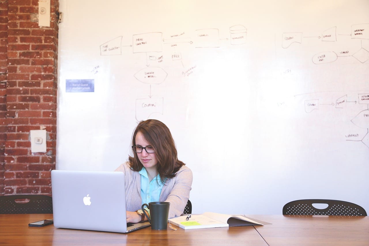 Image of a woman at her computer using tips for a successful video conference meeting