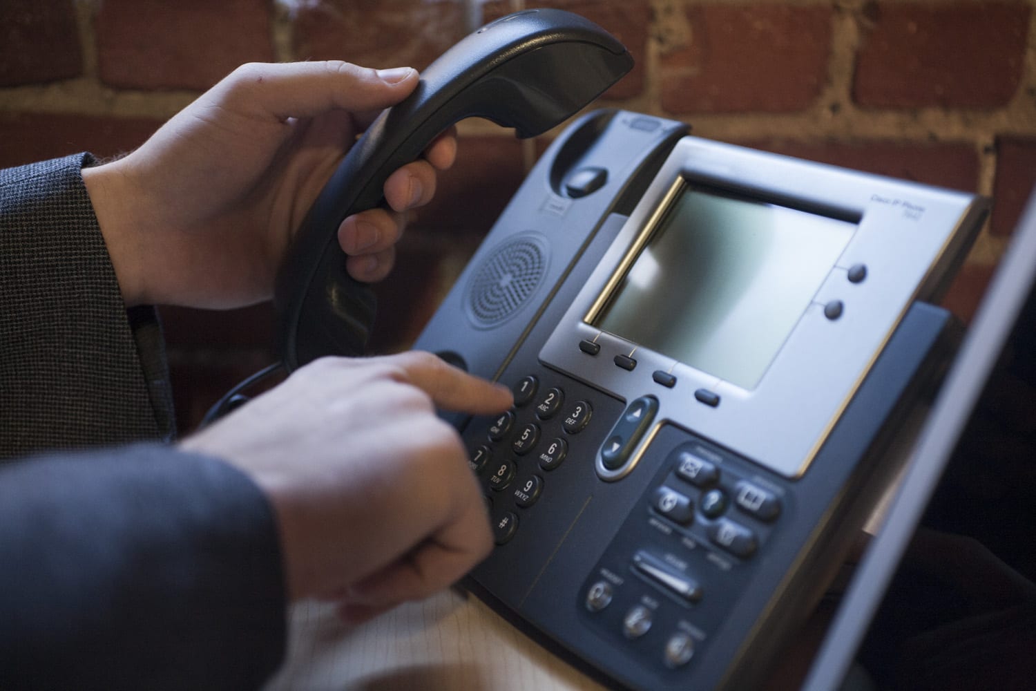 Image of a hand dialing a business with a toll free number