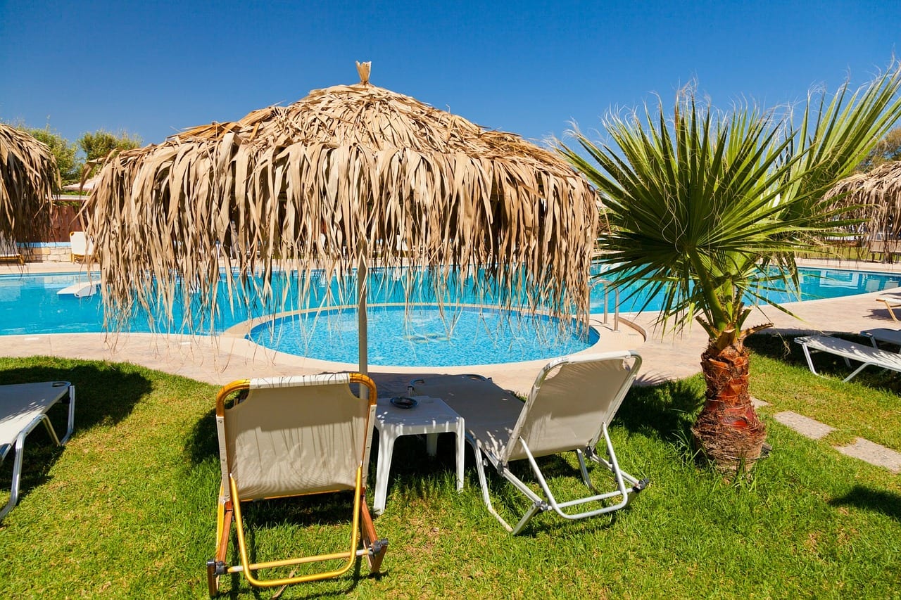 Image of a sunny place to vacation away from work by a pool