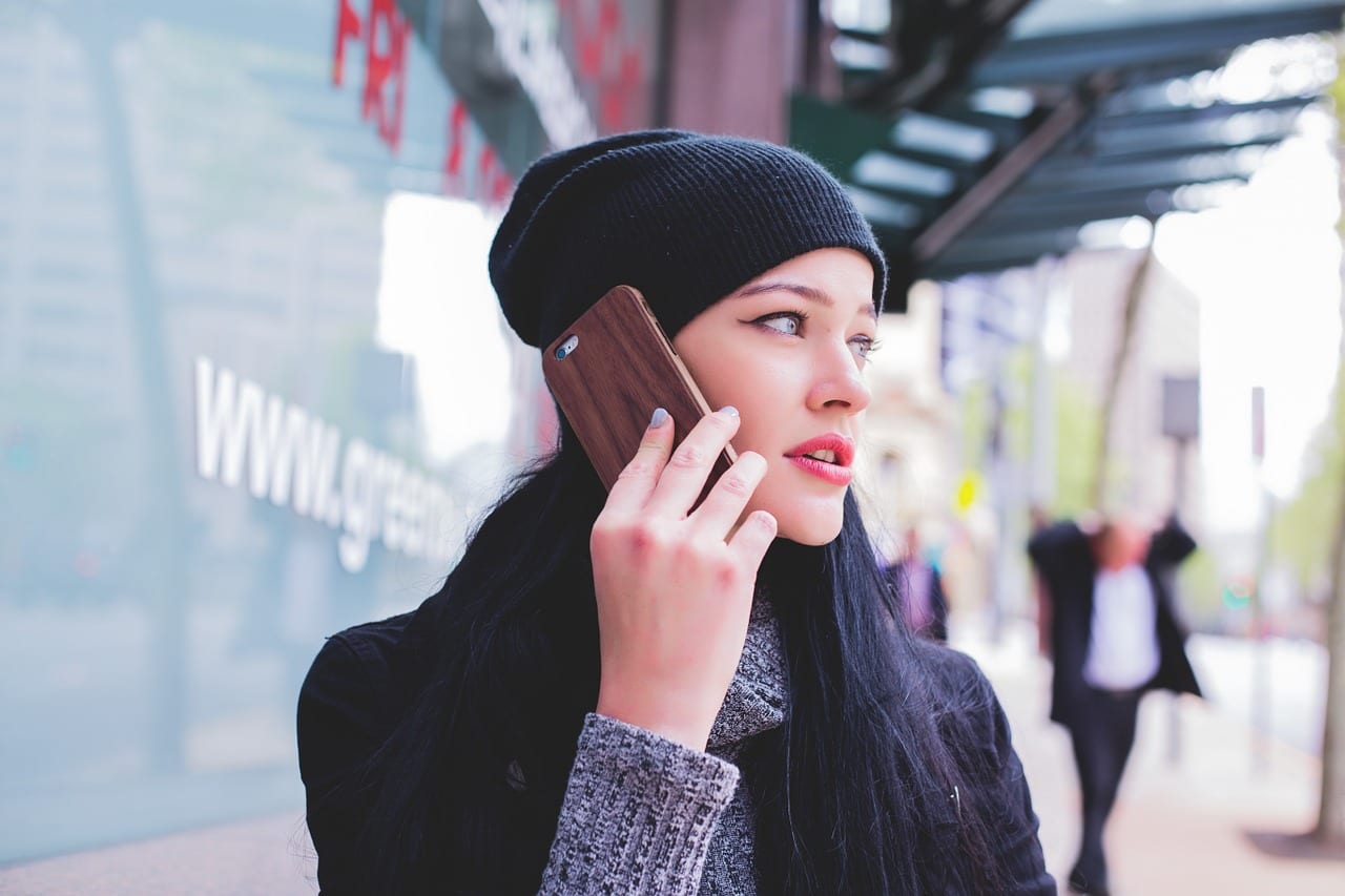 Image of a woman on the phone with an answering service that is dragging out the call