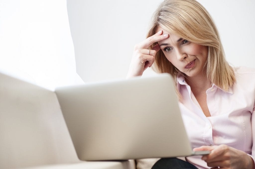 woman looking puzzled at computer