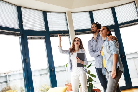 prospective couple being shown around a property