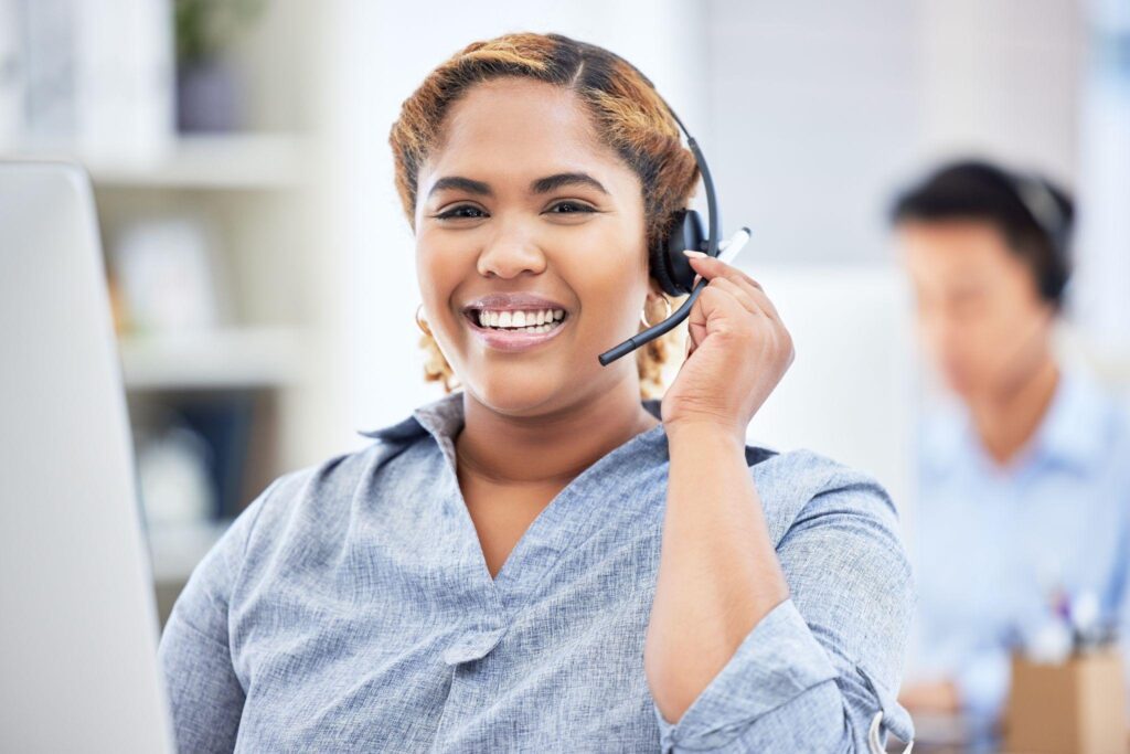 Agent, consultant or professional working at help desk with headset.