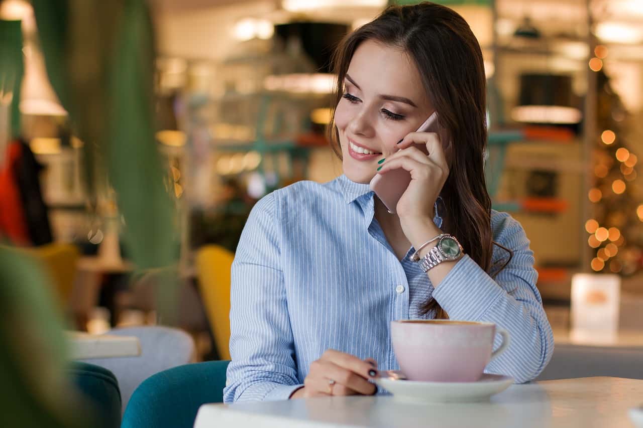 young woman talking on smartphone in cafe