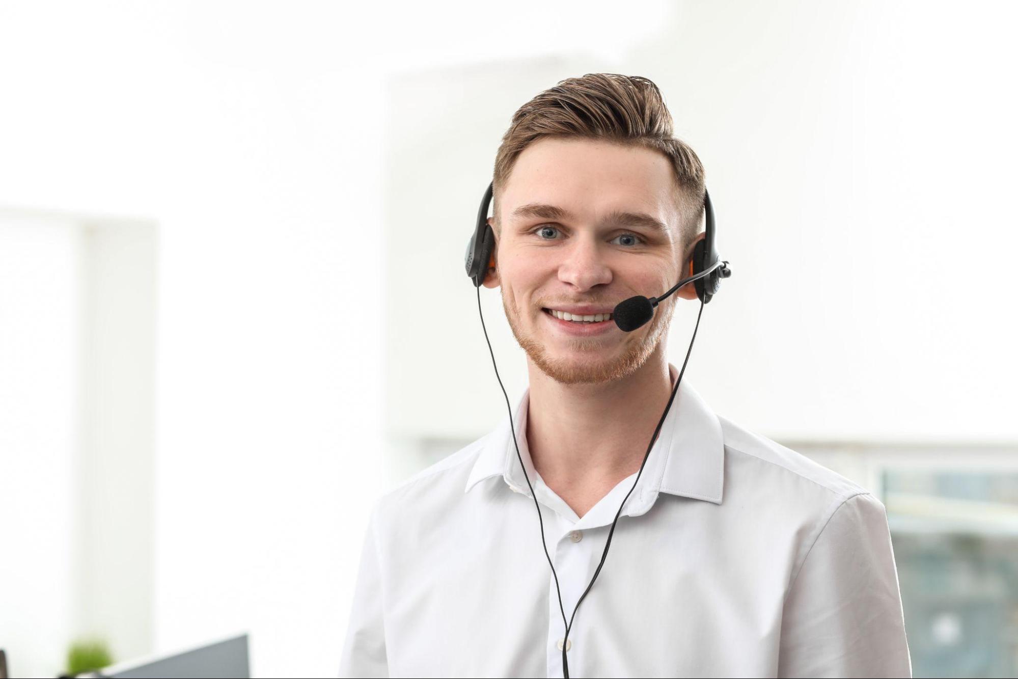 Portrait of male technical support agent in office.