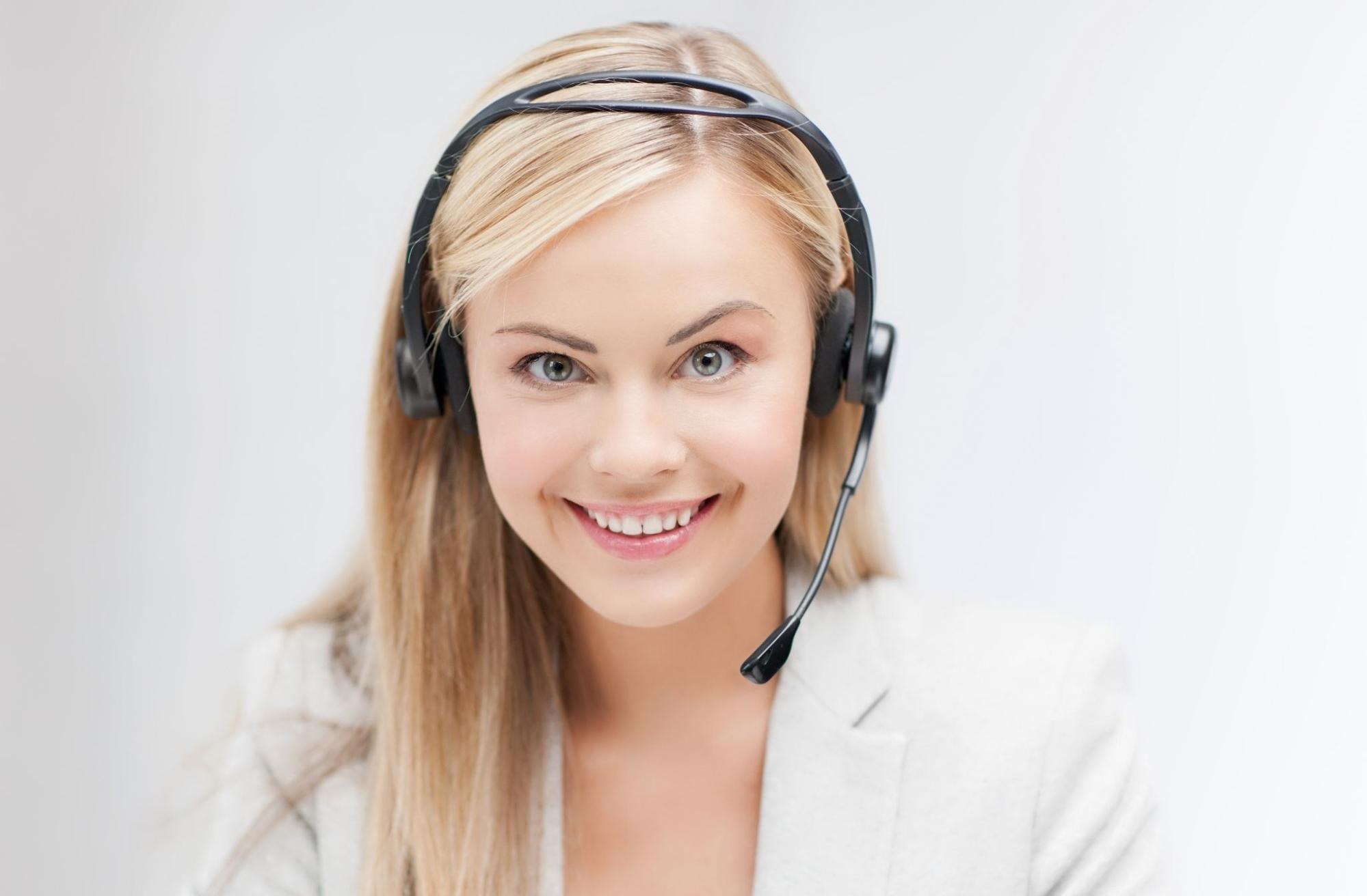 Friendly female helpline operator with laptop.
