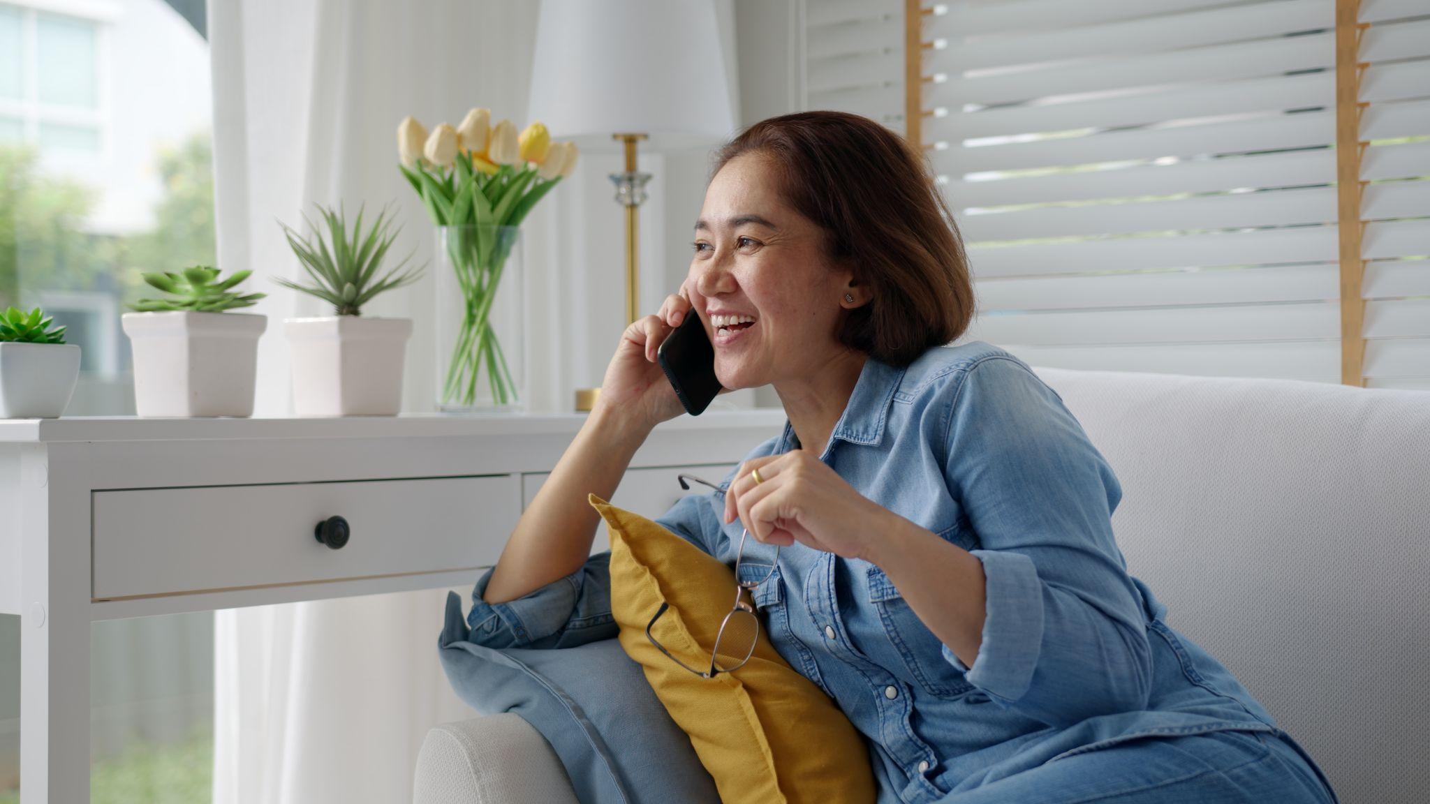 Beautiful woman talking on phone at home