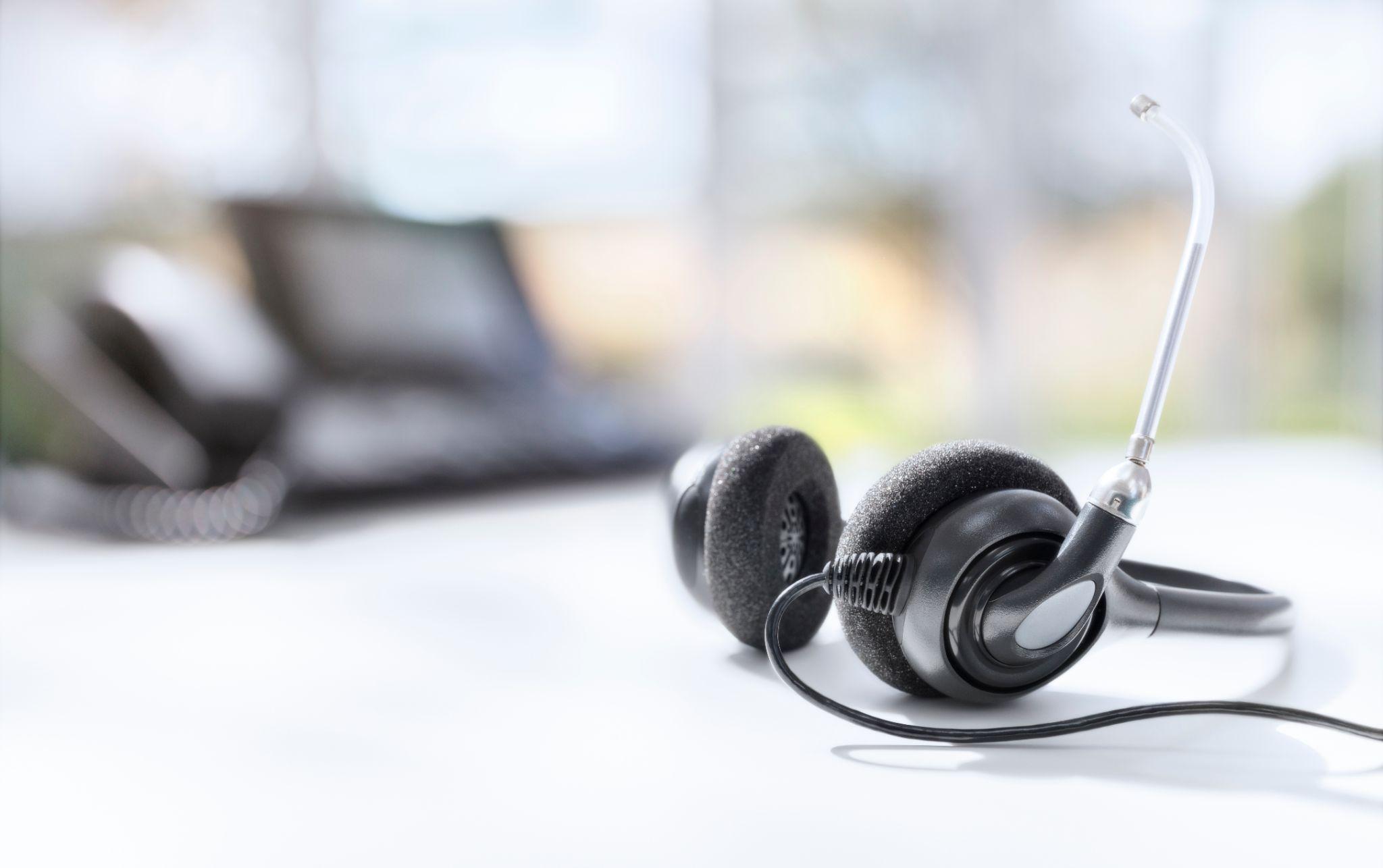 Headset headphones telephone on desk in call center