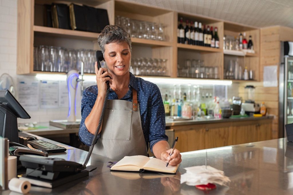 Coffee shop worker taking order over phone