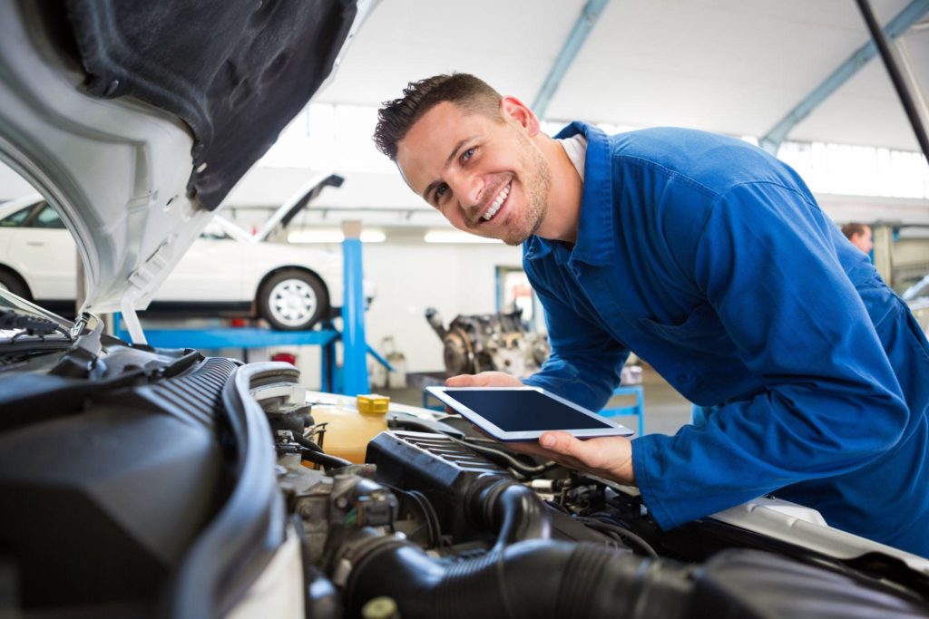 Mechanic using tablet on car