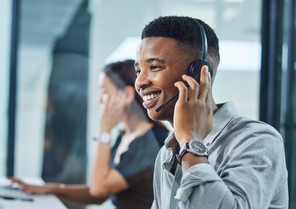 young call centre agent on a call in an office.