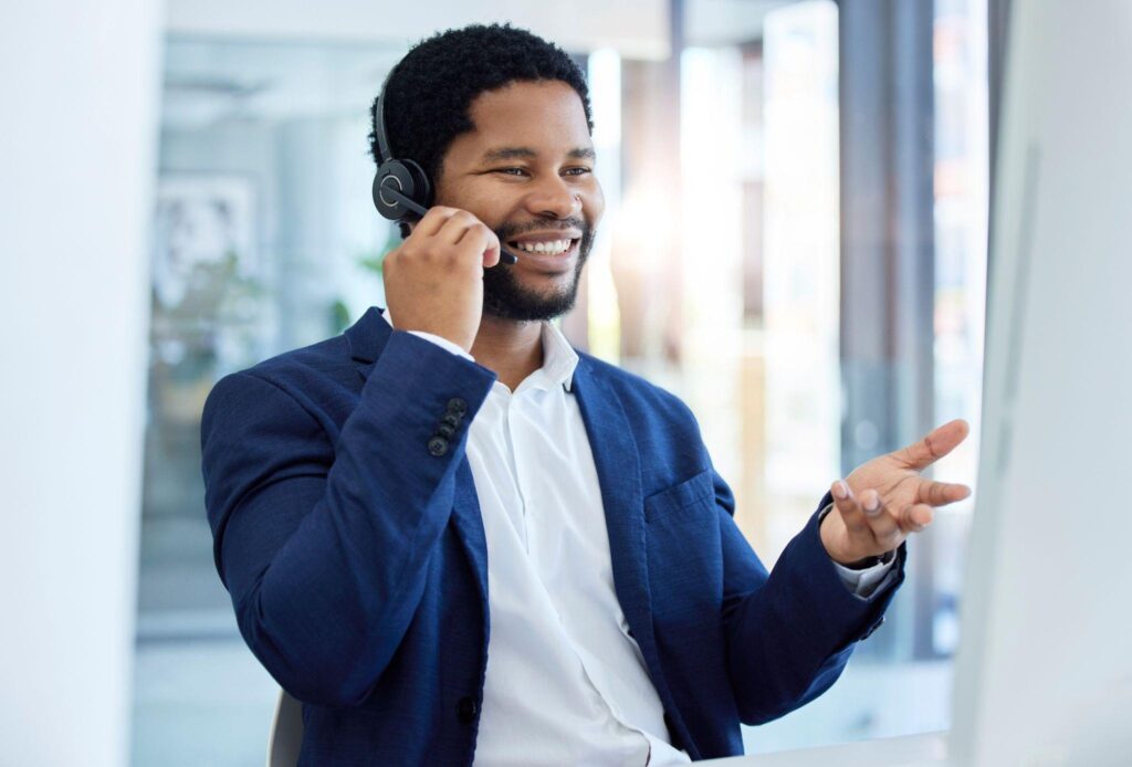 Male telephone answering serivce agent in blue suit with headset.