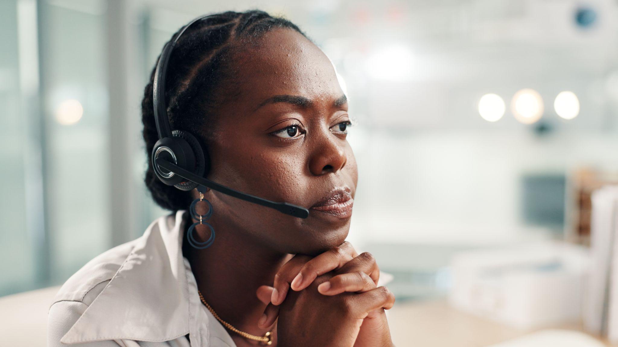 Black woman, consultant or concern with headset at call center for bad news.